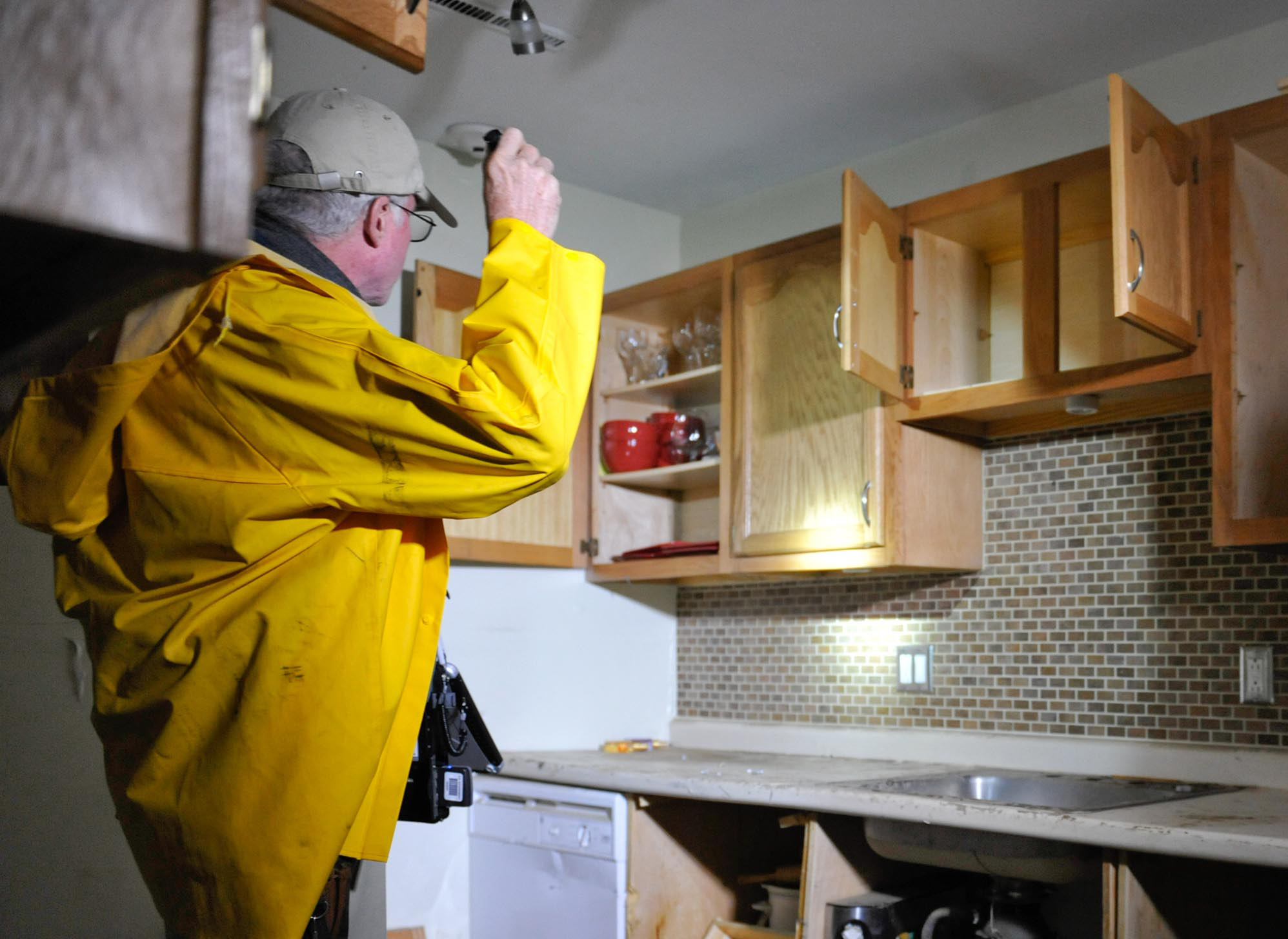 Cranston, RI, April 17, 2010 -- FEMA inspector Mike Irwin with home owner Jose Henriquez run through his home inspection again to illustrate to the media what a FEMA home inspection looks like and what people can expect when they have their homes inspected.  Photo: Michael Rieger/FEMA